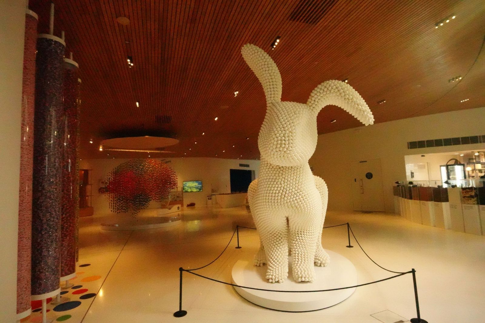 Giant white bunny sculpture in a museum hall
