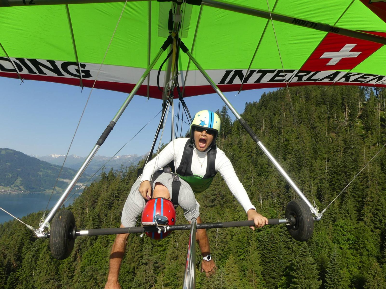 Me screaming on a tandem hang glider while my instructor pretends to have passed out